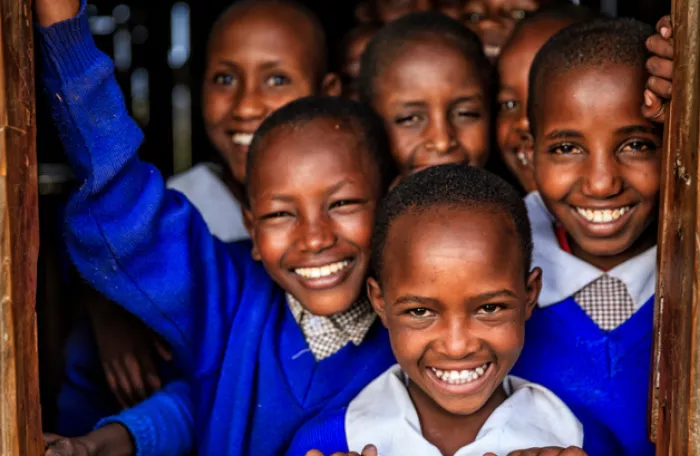 Children in school uniform smiling 