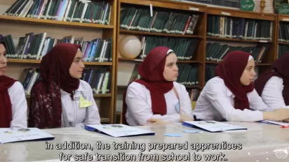 School girls in school uniform in Egypt seat at a table and listen to a lecture