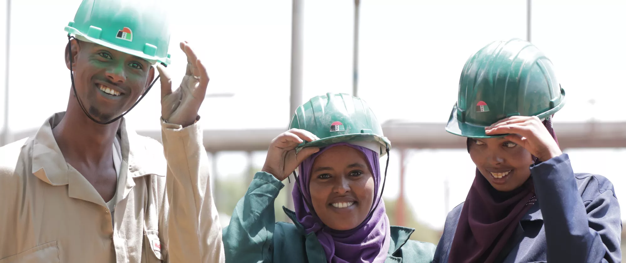 students of technical schools wearing helmets smiling